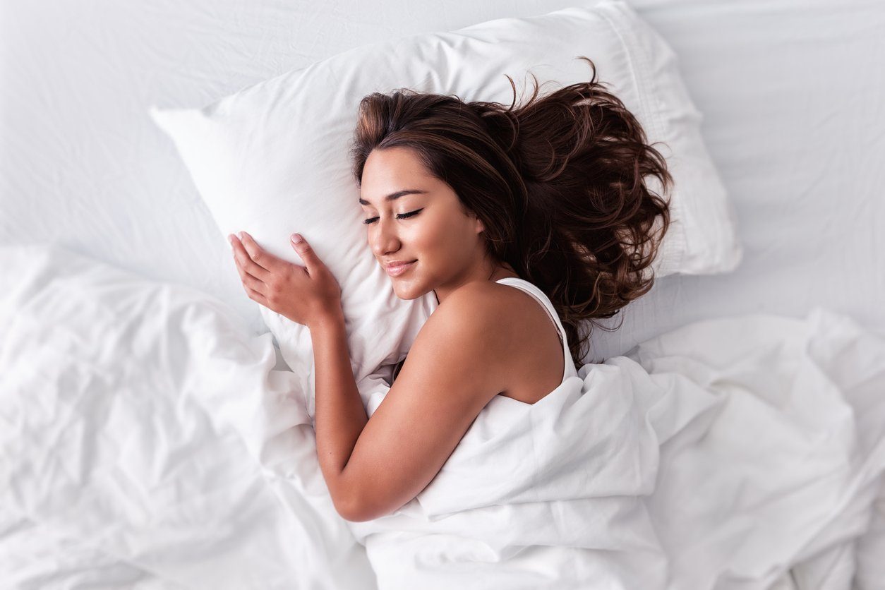 Woman sleeping blissfully with the best pillow for all positions