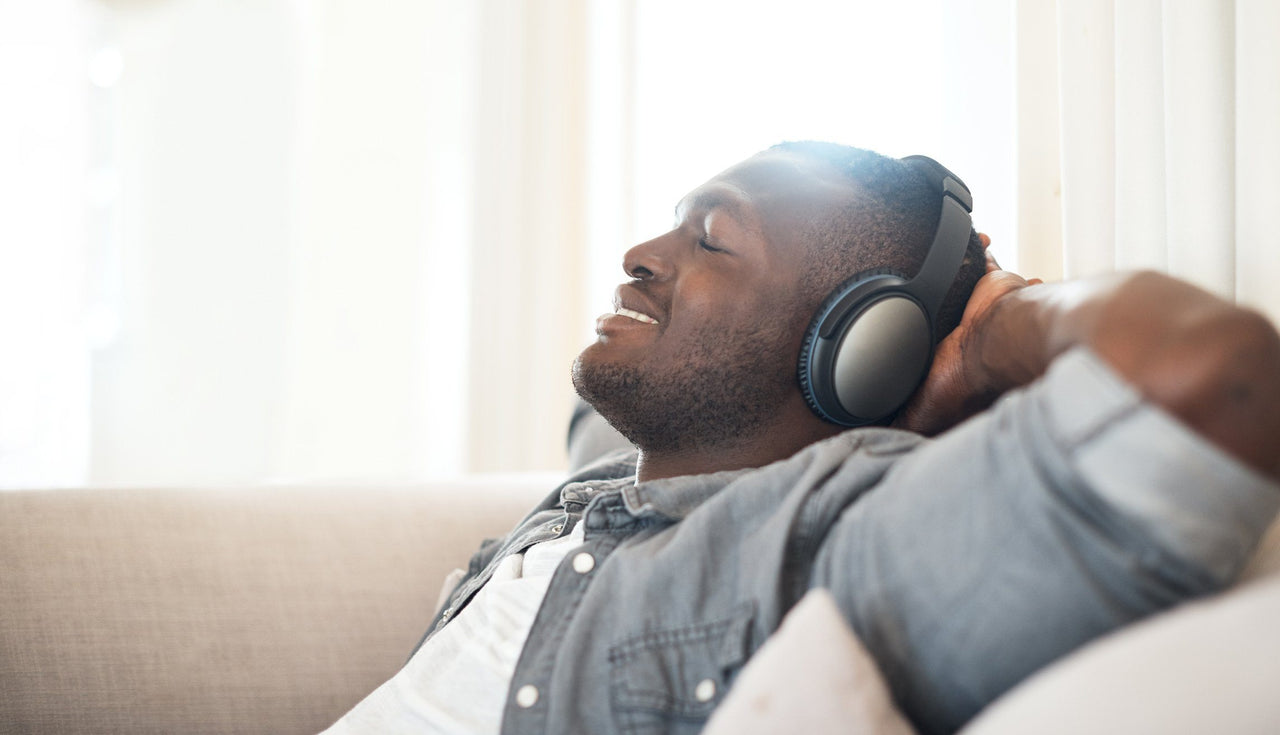 man relaxing with headphones as binaural beats help you sleep