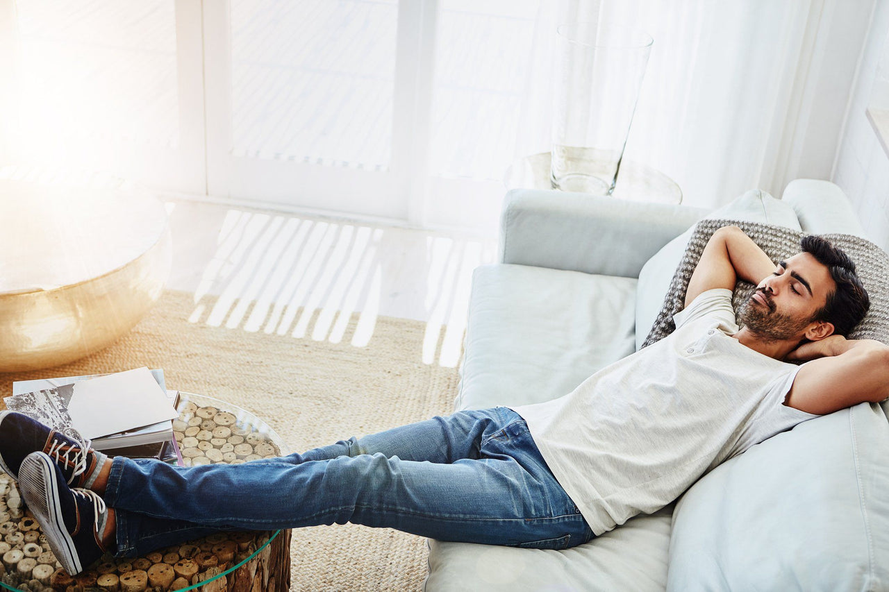 man resting on couch with the science of naps