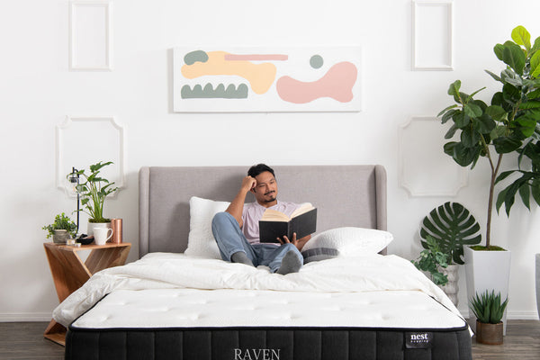man in bed reading a book