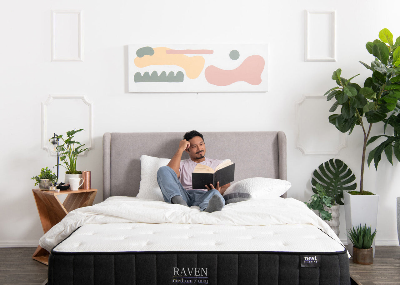 man in bed reading a book