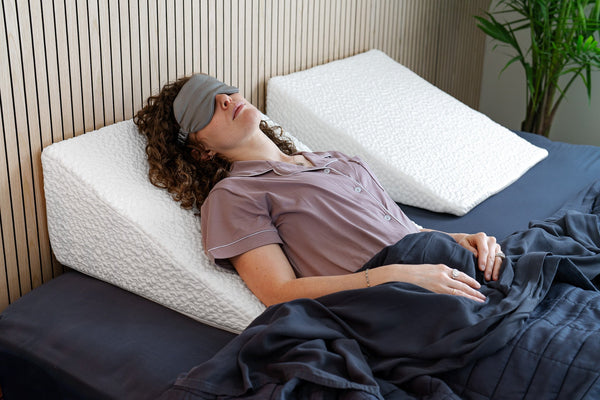 Woman lying on easy breather pillow with eye mask
