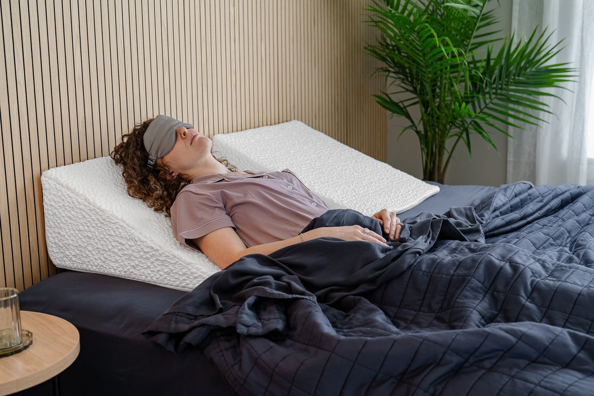 Woman sleeping on easy breather pillow with eye mask