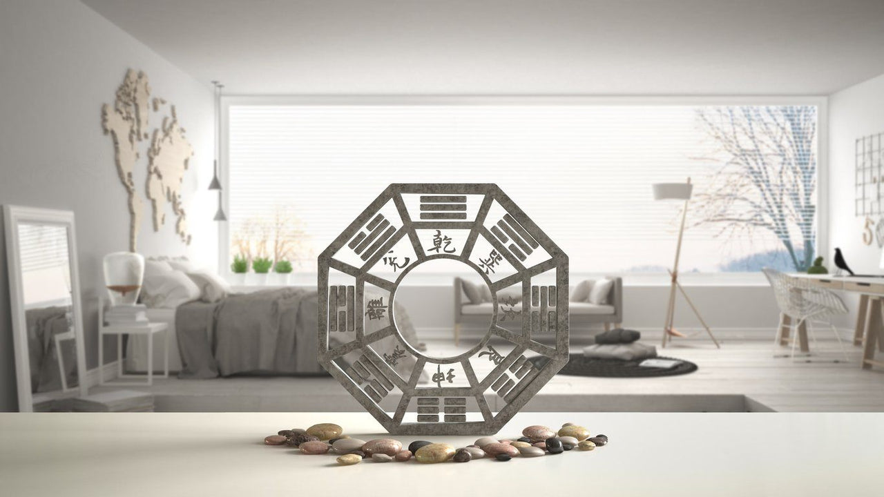 Feng Shui Bagua with pebbles in front of minimalist bedroom