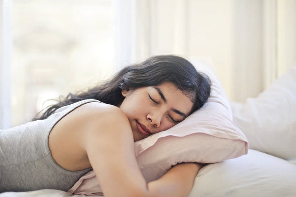 woman laying on pillow in bed