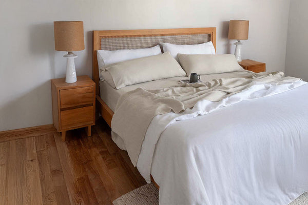 Bedroom with wooden bed frame, nightstands, and lamps.