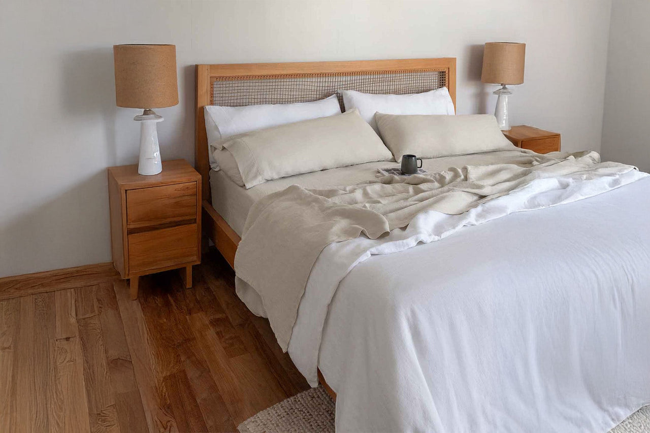 Bedroom with wooden bed frame, nightstands, and lamps.