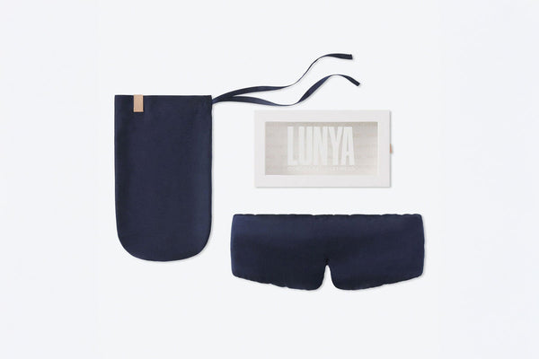 Deep blue silk sleep mask, pouch, and LUNYA packaging displayed on a white background