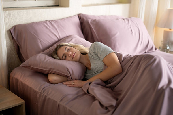 Woman lying down sleeping in bed