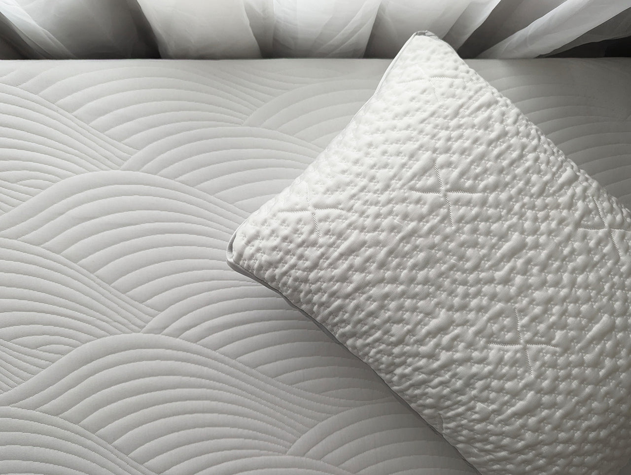 an easy breather jr pillow on top of the cooling topper