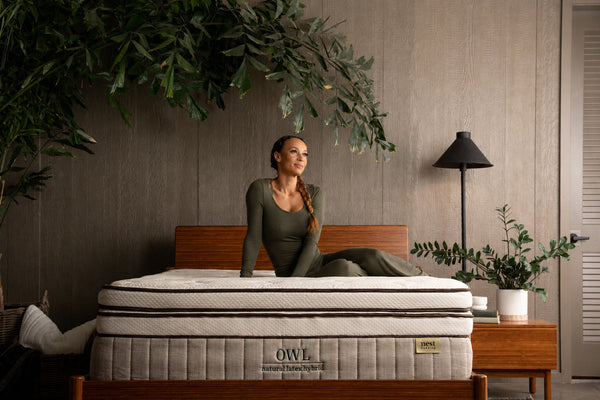 greenery, bedroom scene, woman sitting comfortably on the Soft Latex Topper