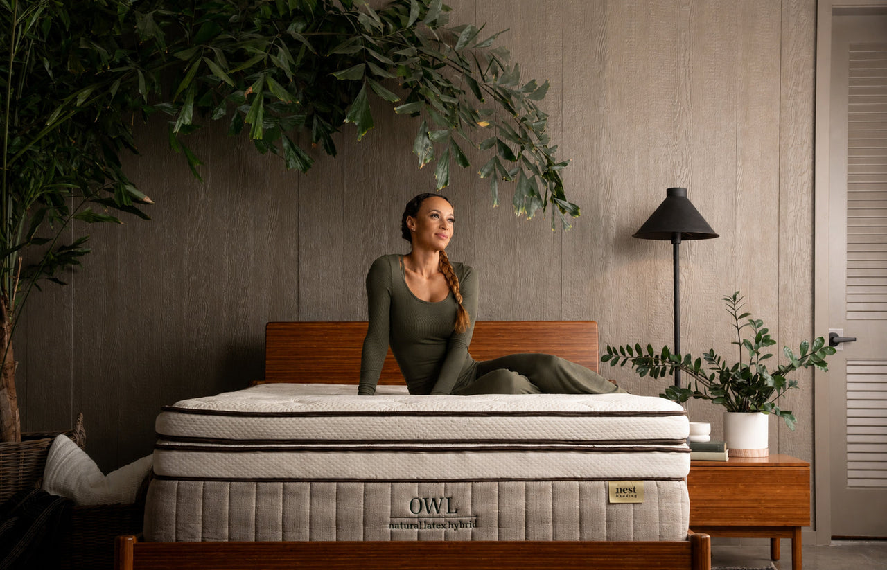 greenery, bedroom scene, woman sitting comfortably on the Soft Latex Topper