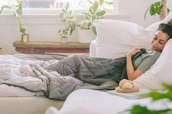 Woman resting in bed covered in a blanket