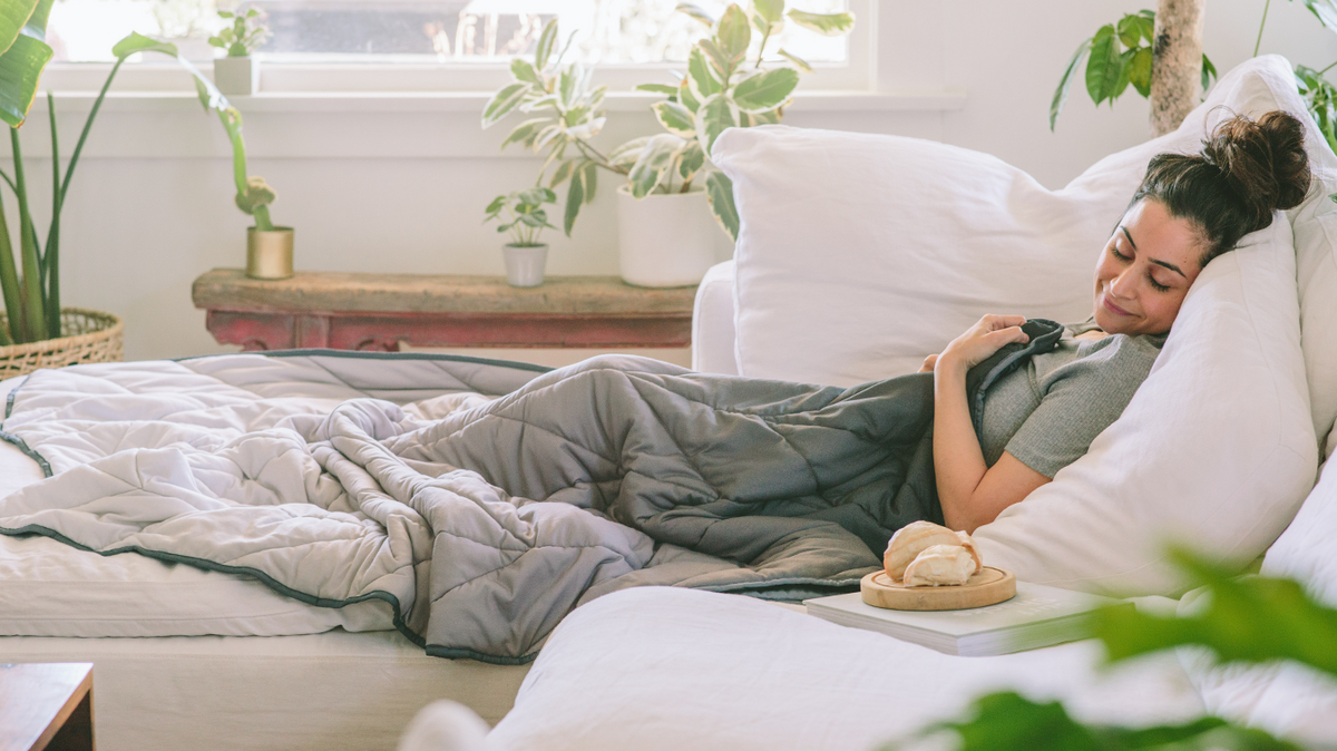 Woman resting in bed covered in a blanket