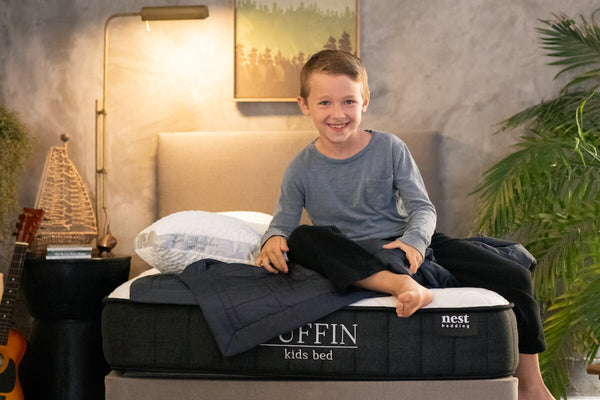 Child sitting on a puffin mattress in his bedroom