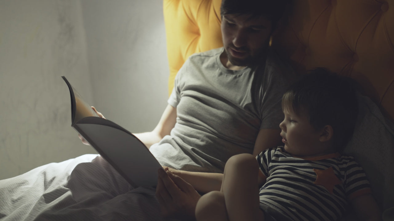 Father reading bedtime story to son which is the language of sleep