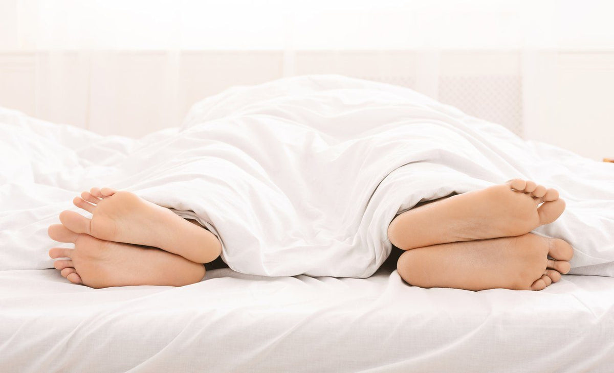 feet sticking out from blanket facing away