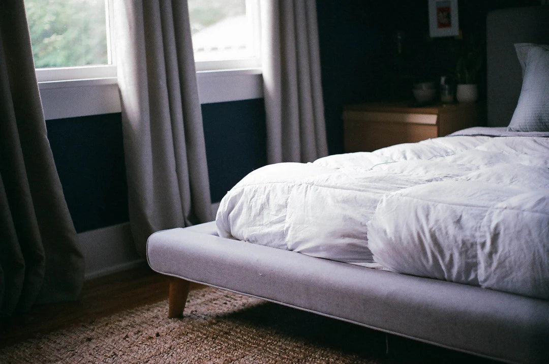 a corner angle of a bed in a modern and moody bedroom