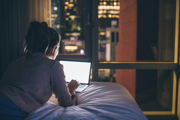 In bed on the laptop with blue light at night