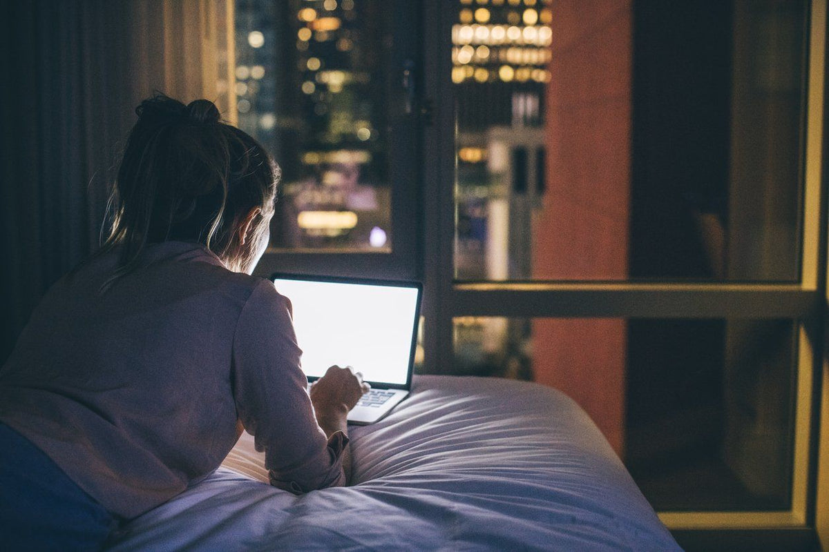 In bed on the laptop with blue light at night