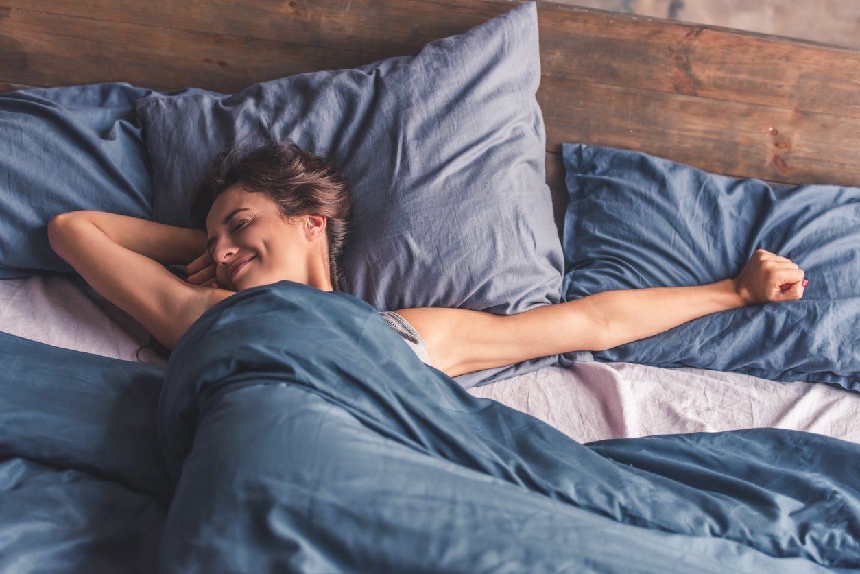 Sleepy woman feeling the health benefits of a good night's sleep