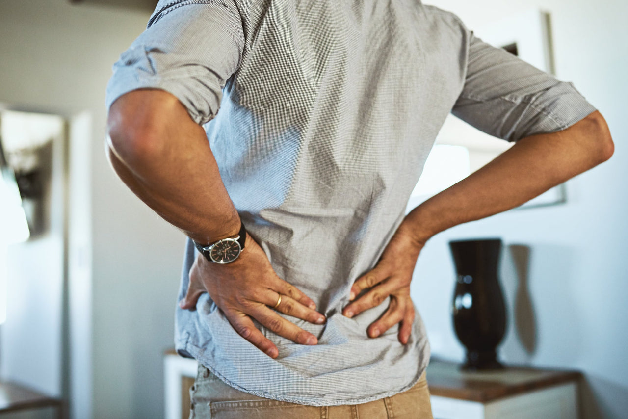 Man grabbing his lower back in pain
