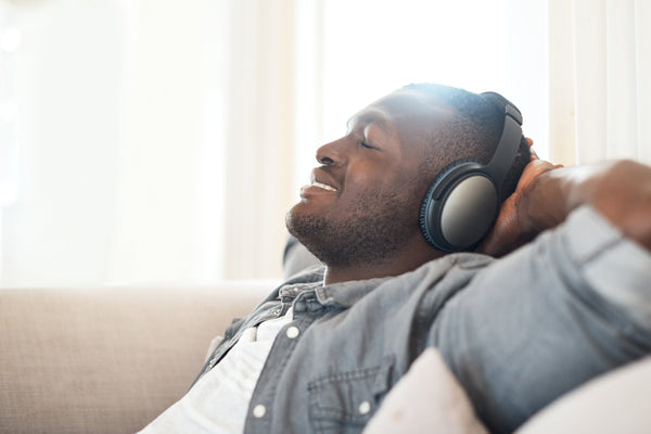 man relaxing with headphones as binaural beats help you sleep