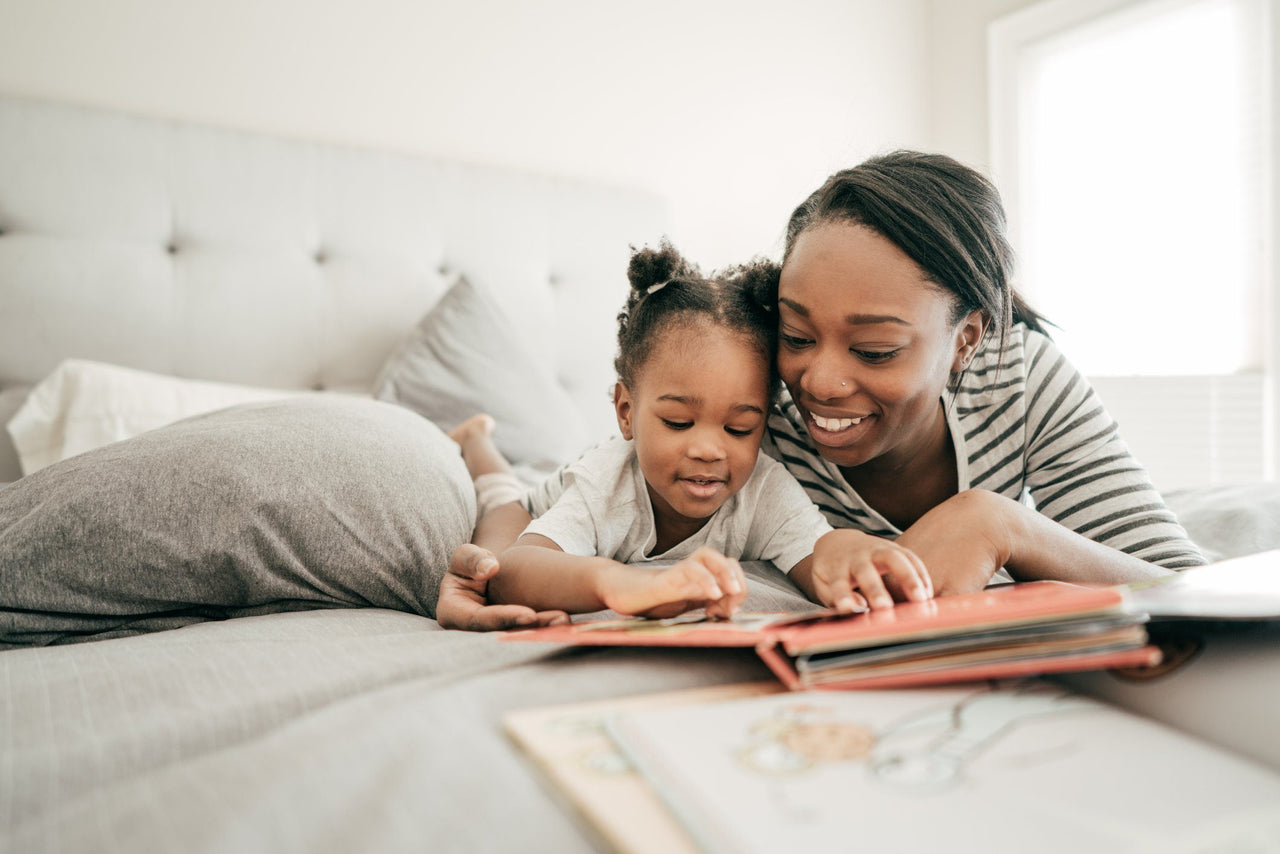 mother reading to daughter before the kid’s bedtime