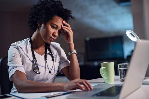 nurse at computer working the night shift