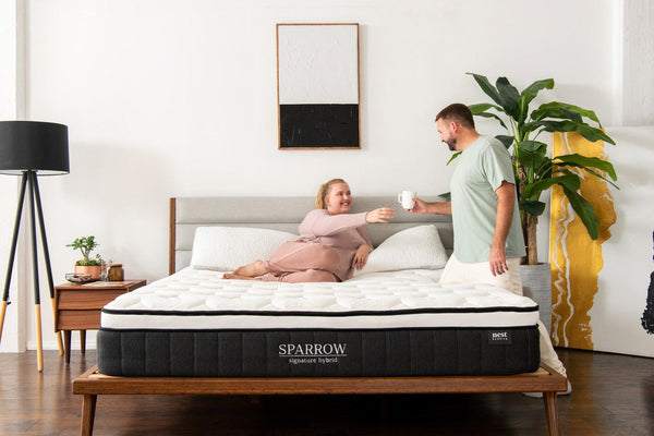 Couple on Sparrow Mattress sharing a cup of coffee