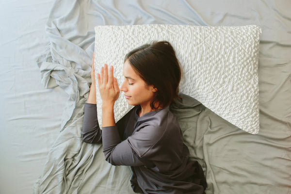 Woman lying down on neck support pillow