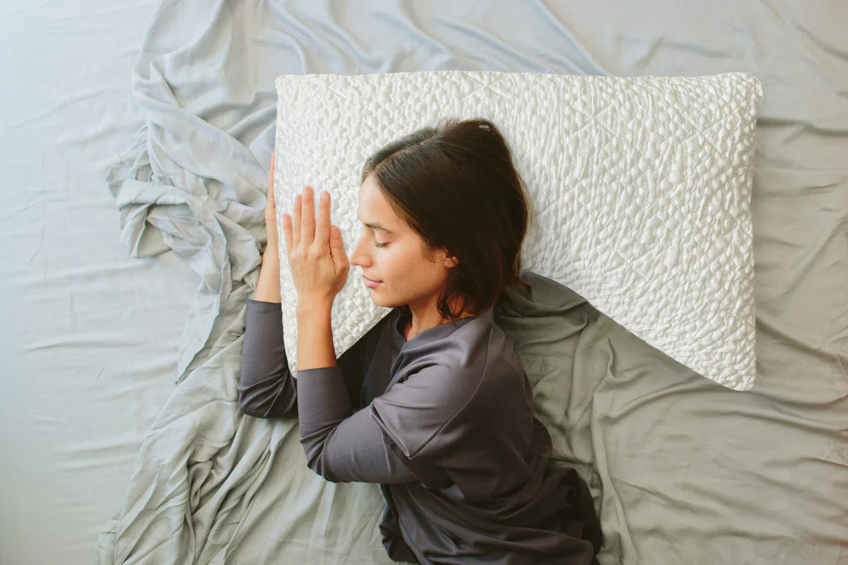 Woman lying down on neck support pillow