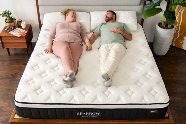 a couple laying happily on the sparrow mattress