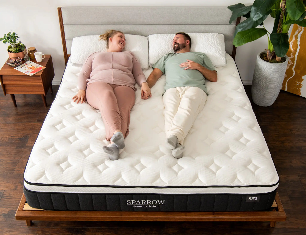 a couple laying happily on the sparrow mattress