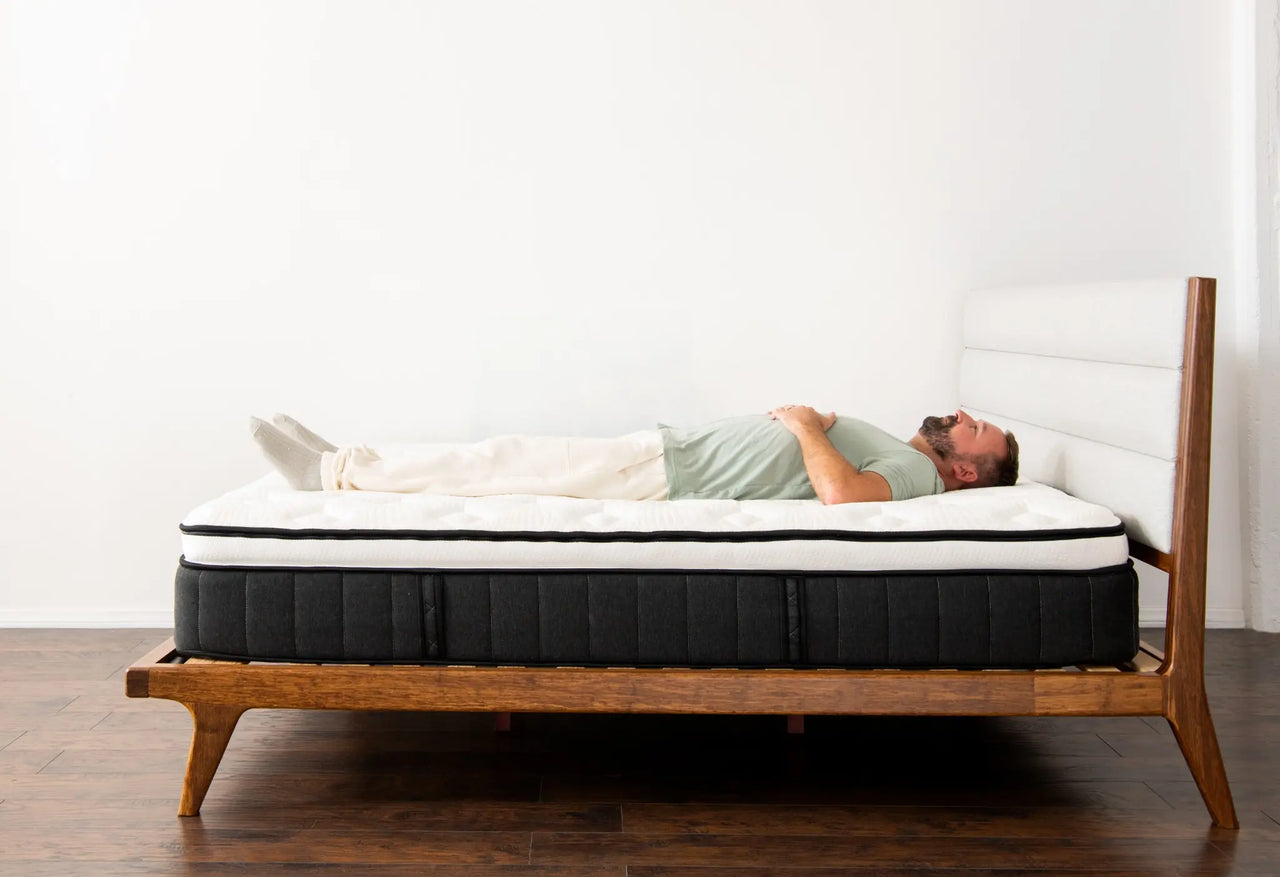side profile of a man laying on the sparrow mattress