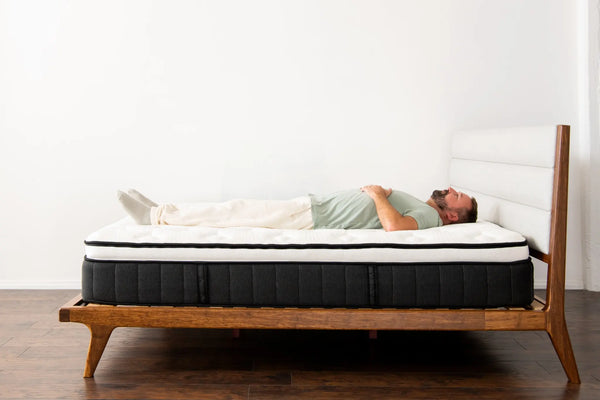 side profile of a man laying on the sparrow mattress