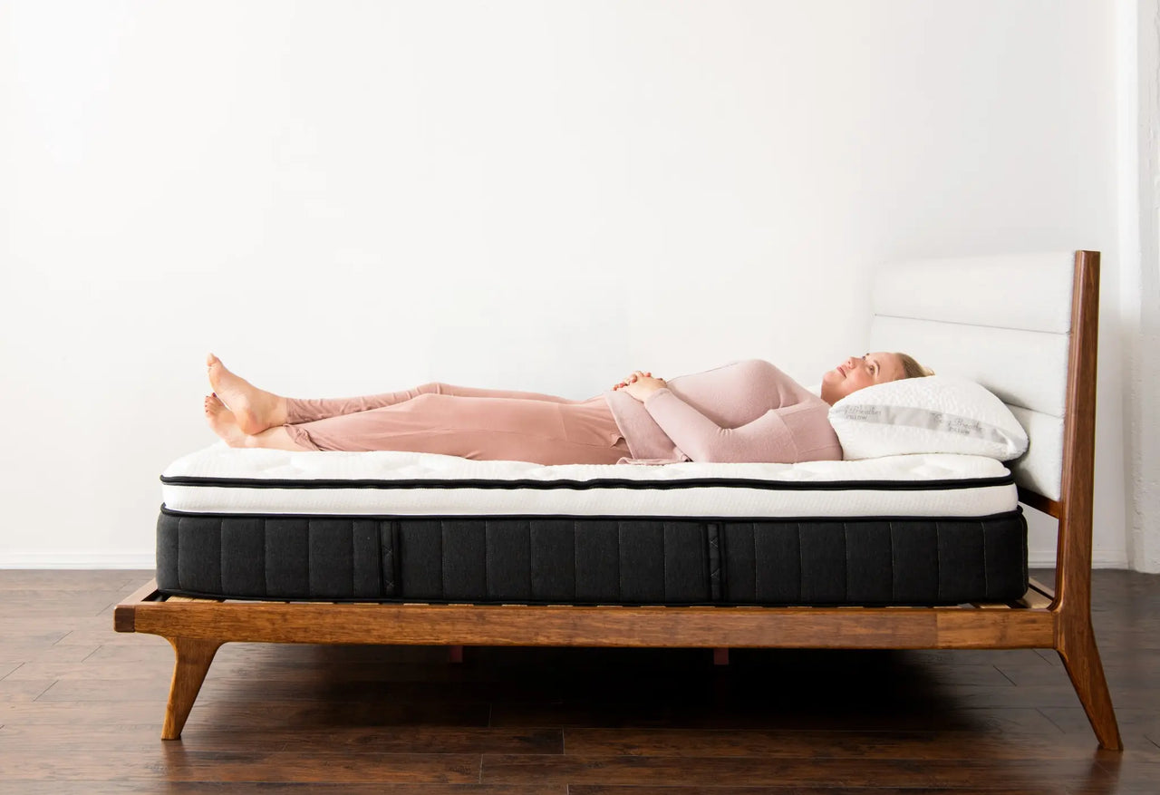 woman demonstrating the Sparrow mattress's back support for back sleepers