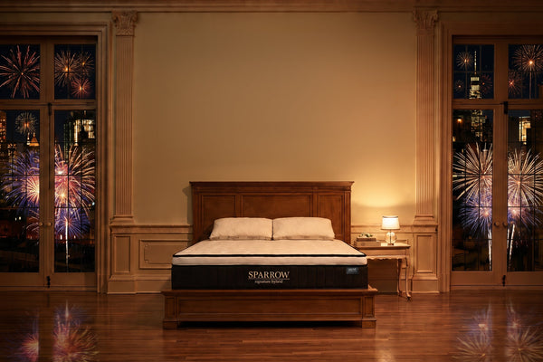 sparrow mattress in a luxury bedroom with fireworks all around outside the windows