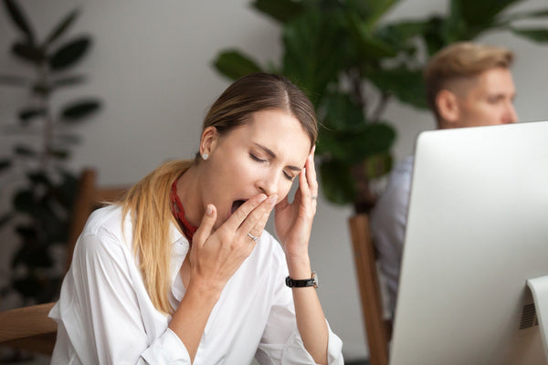 tired businesswoman yawning after a sleepless night