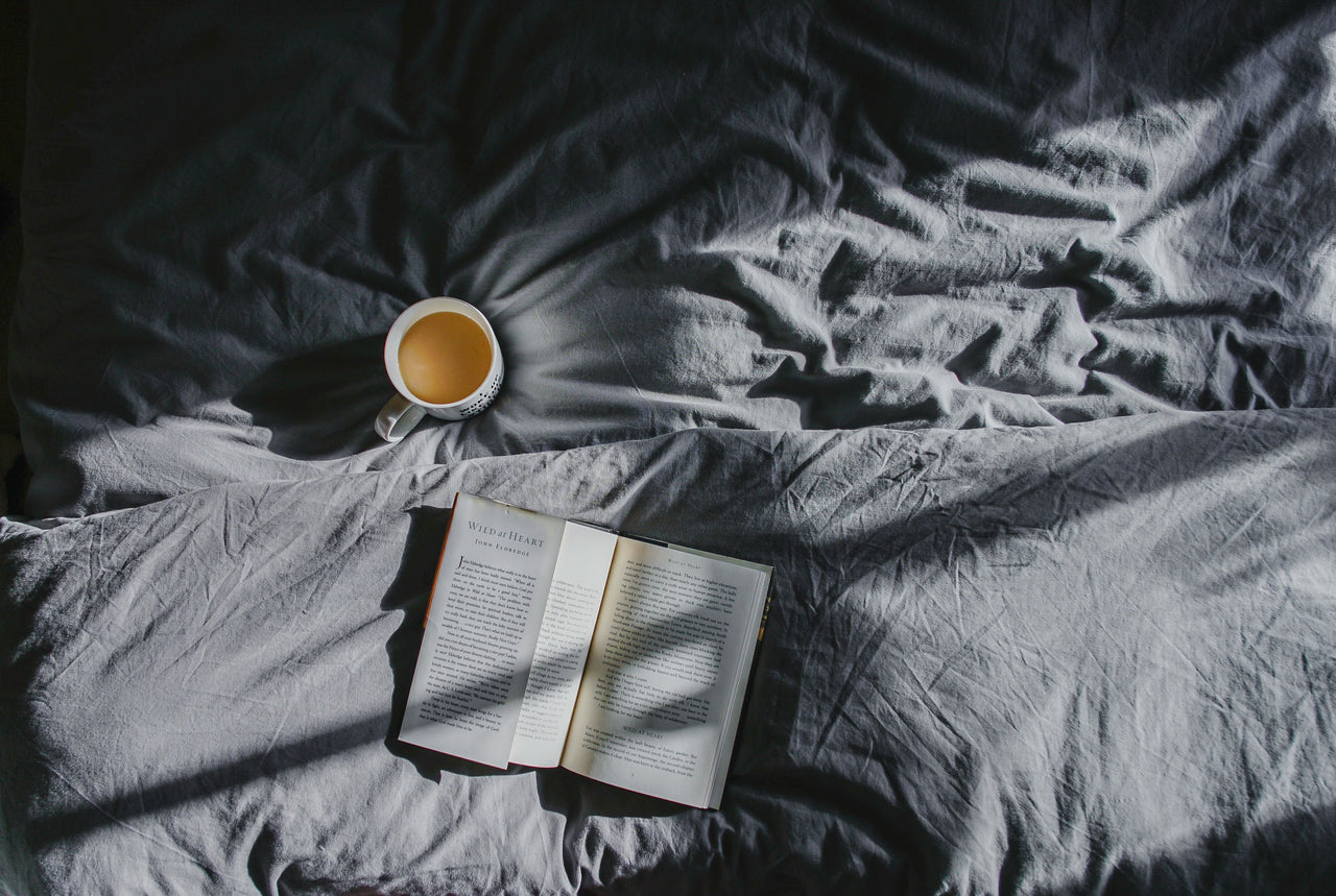 Drinking tea and reading a book for a nighttime routine