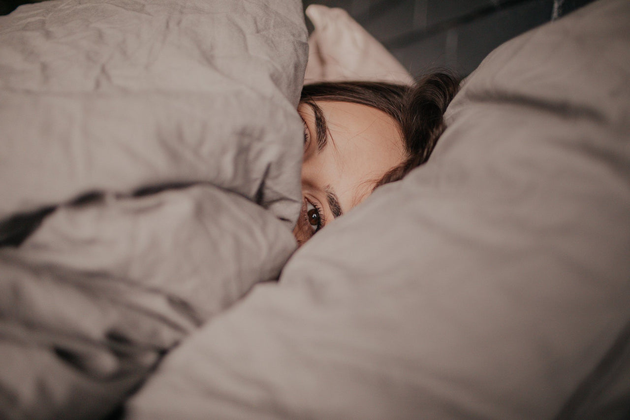 woman in bed struggling with shift work sleep disorder