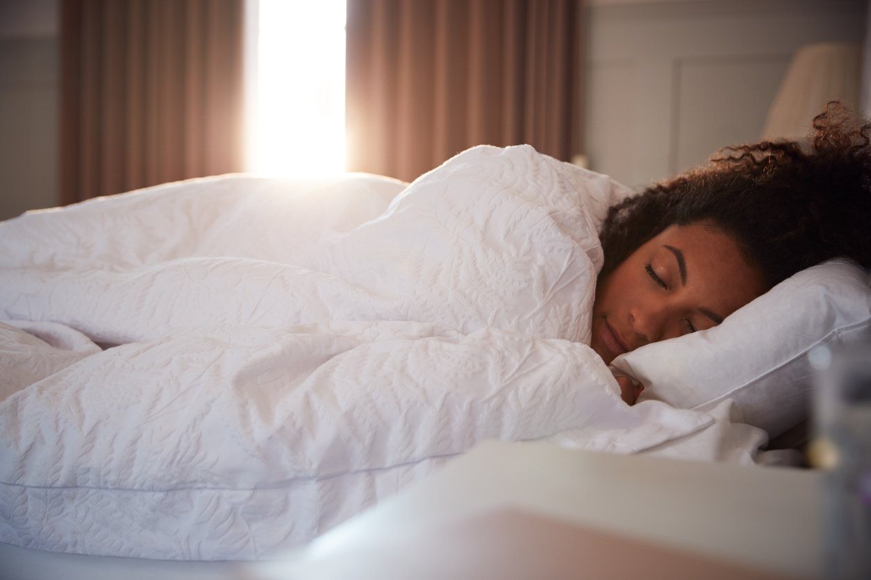 woman sleeping during daylight with drapes open
