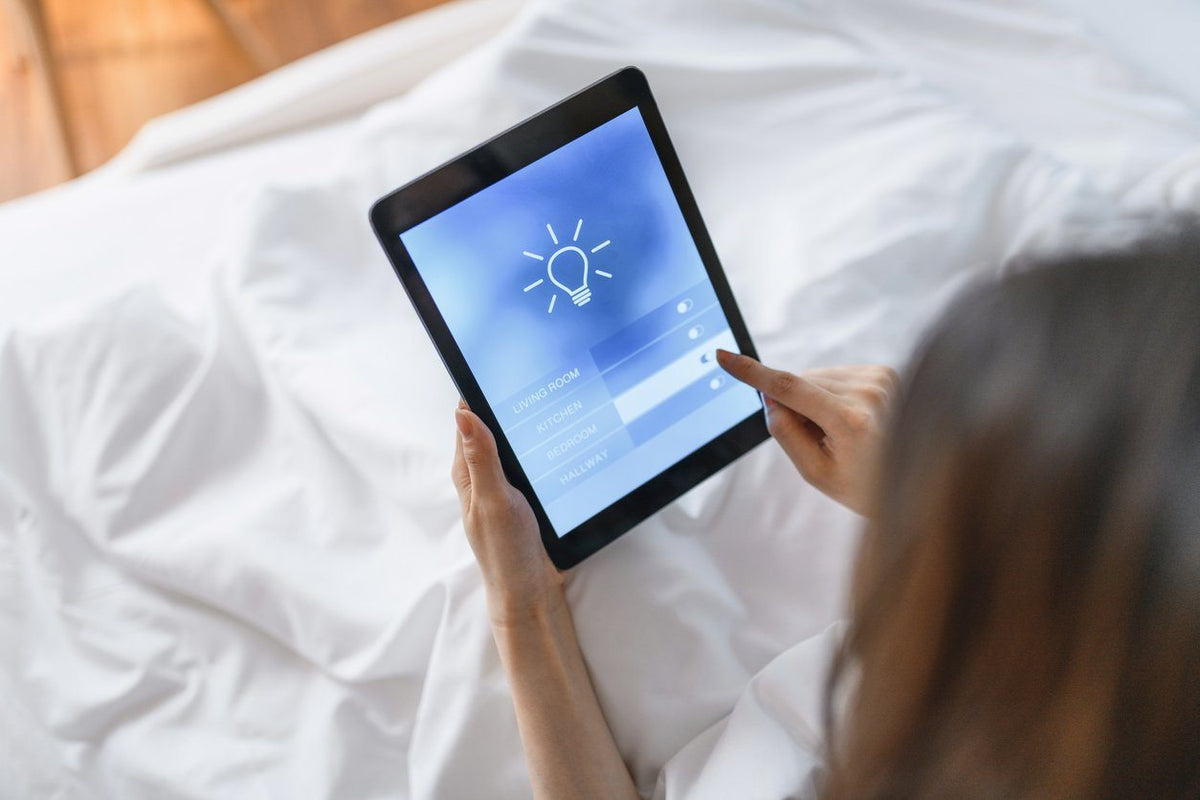 woman touching tablet for smart home lighting