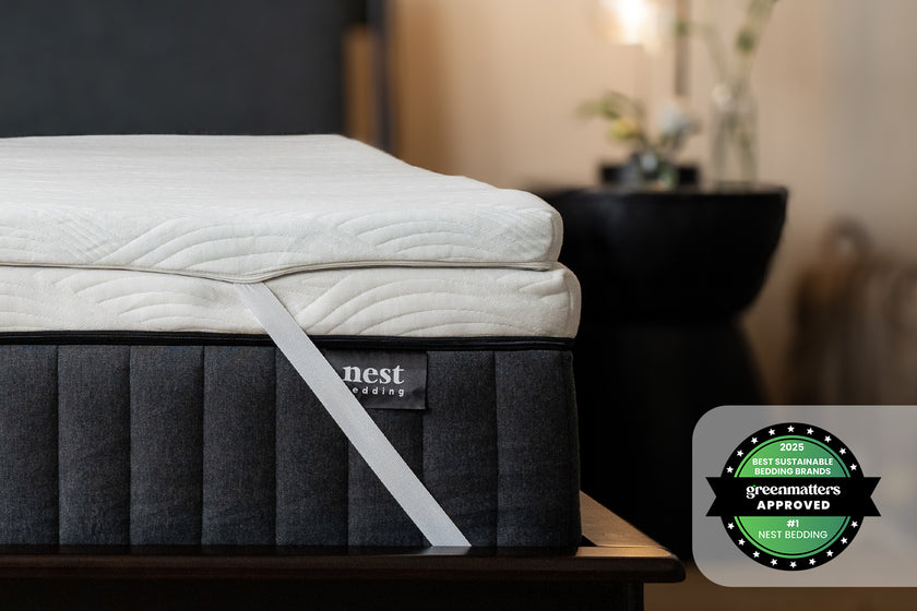 Cooling Topper corner strap wrapped around the Starling signature contour grid mattress, bedroom scene, and greenmatters approved 2025 best sustainable bedding brands award badge
