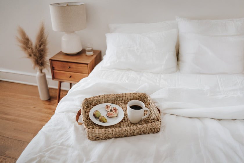 Bedroom with a tray of coffee and pastries on a white bed