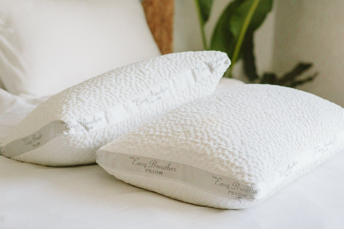 two easy breather pillows stacked next to each other in a bedroom